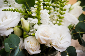 Elegant white bouquet of flowers and leaves macro closeup