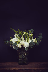 white flowers on an old wooden board with black chalkboard