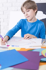 Boy coloring the picture