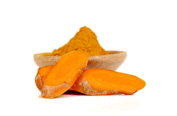 Fresh Turmeric,Turmeric powder on wooden spoon placed on white b