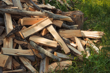 a pile of scattered wood on the grass