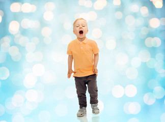 happy little boy shouting or sneezing