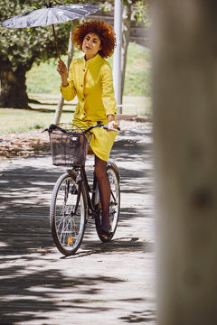 Redhaired beauty woman fashion girl on bicycle with chinesse umb