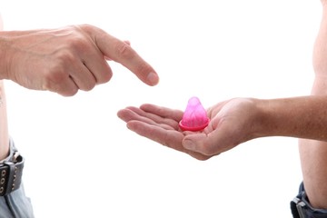 close up of male gay couple hands giving condom