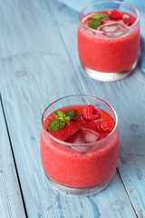 smoothie of strawberries and raspberries on old boards