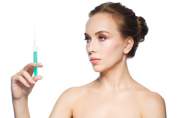 beautiful woman holding syringe with injection