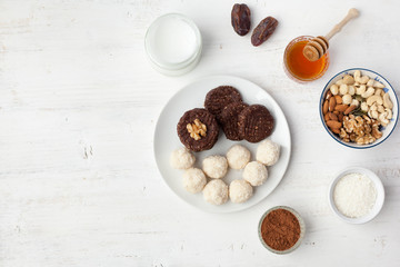 Raw vegan paleo style cookies selection, made with nuts, coconut oil, honey and dates, top view, selective focus on walnut