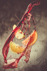Sangria ingredients flying in wine splashes
