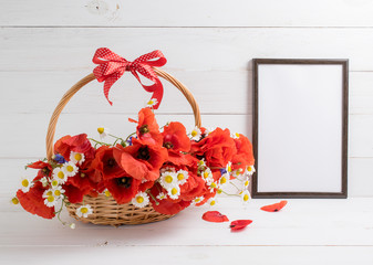 Red poppies bouquet in  basket with motivational frame