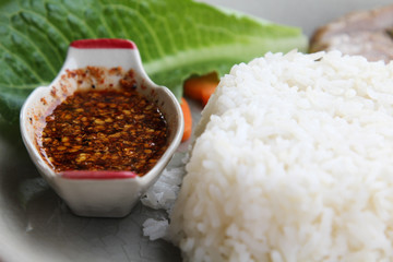 Thai cuisine fried pork with rice on dish.