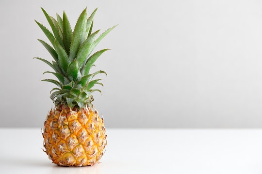 Ripe pineapple on a white table
