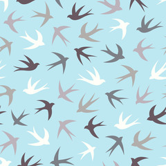 Seamless pattern with a flock of swallows. Vintage background of silhouettes of birds in the sky. Vector illustration.