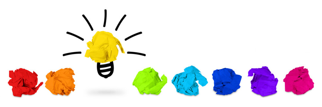 brainstorming idea concept row of rainbow colored paper snarl with light bulb symbol / Idee Konzept mit reihe Papierkugeln in Regenbogen Farbe und Gl&uuml;hbirne Symbol