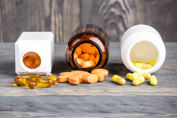 Various medicine pills and containers on tabletop