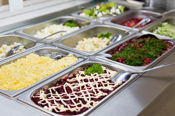 Salads in restaurant on the metal plates.
