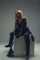 Blond female in motocycle clothes.