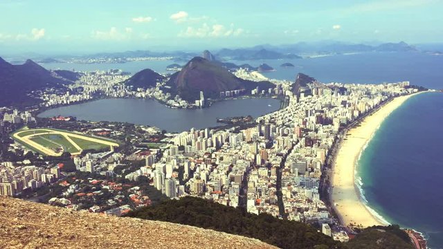 Scenic timelapse view of Ipanema Beach and Lagoa as viewed from the top of Dois Irmaos (Two Brothers) Mountain in Rio de Janeiro, Brazil