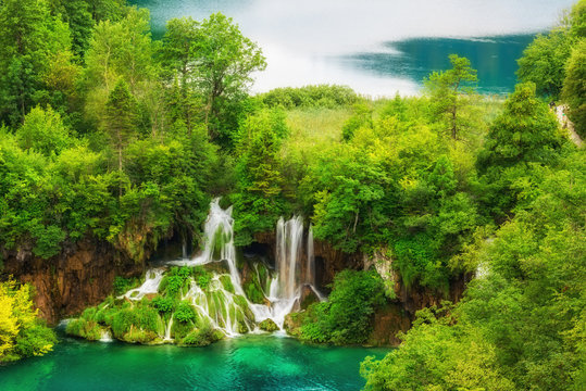 Plitvice Lakes National Park amazing emerald lakes and waterfalls, surrounded by forests in Croatia, nature background suitable for wallpaper or guide book