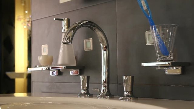 Silver faucet water in bathroom