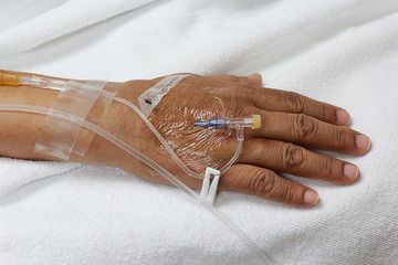 the intravenous fluid in a patient hand.