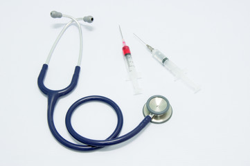 Close up medical syringes with medicine and stethoscope