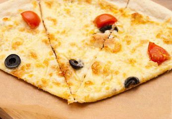 Focaccia with mozzarella and tomatoes on a wooden board