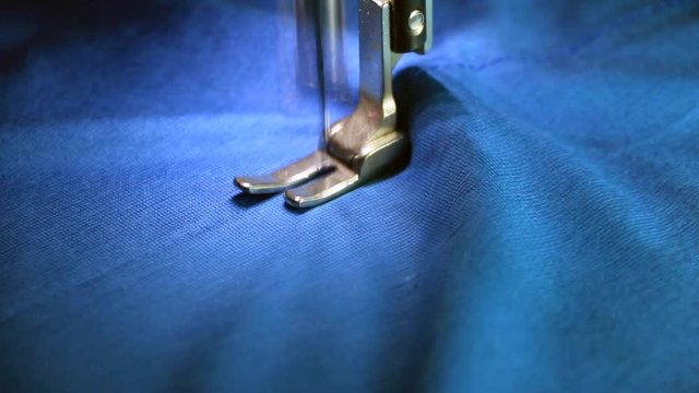 Professional sewing machine with blue fabric