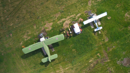 retro airplane green color with red stars on the wings and small modern plane aerial view