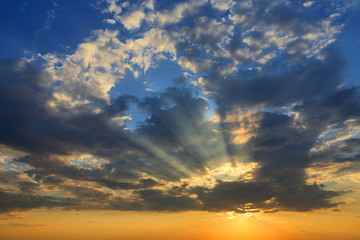 Sunset sky. Incredible colors of the evening sky with storm clouds and sun rays.