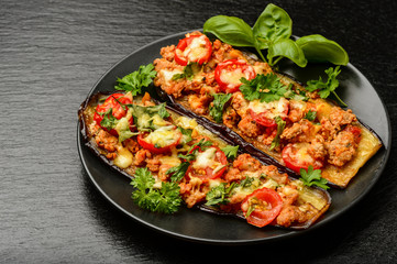 Delicious appetizer -grilled eggplants baked with minced meat, tomatoes and cheese.