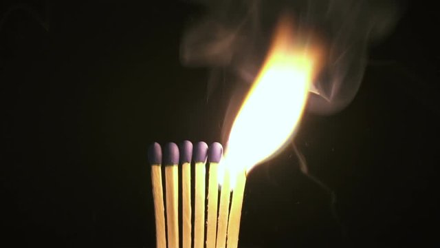 Burning match in the dark. Slow Motion