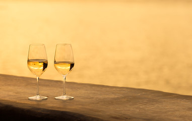 Romantic summer holiday by the sea.  Pair of wine glasses by the sea.