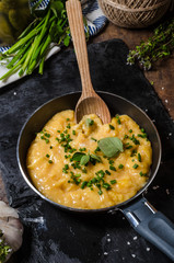 Scrambled eggs in a frying pan