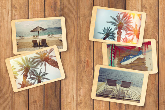 Summer holiday vacation photo album with instant photos on wooden table
