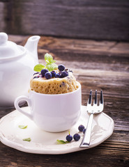 Blueberry Microwave Muffin in mug . Selective focus