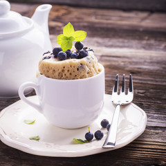 Blueberry Microwave Muffin in mug . Selective focus