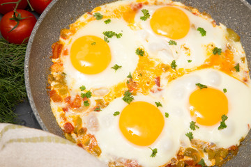 Shakshuka - traditional dish of israeli cuisine in a skillet pan
