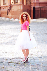 Young adult girl in purple keds and fluffy skirt