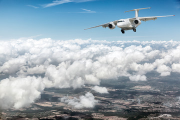 Fototapeta na wymiar Airplane over the clouds.