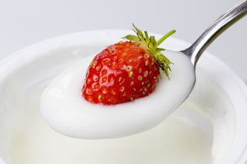 close-up of spoon of yogurt with strawberries