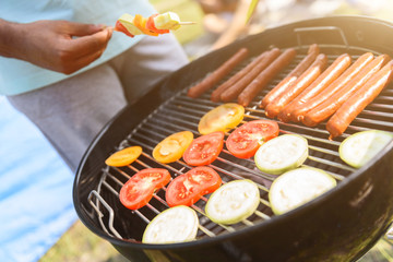 Young guy cooking food outdoors