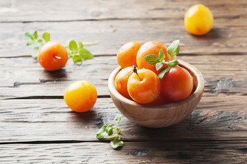 Sweet fresh yellow plums on the wooden table