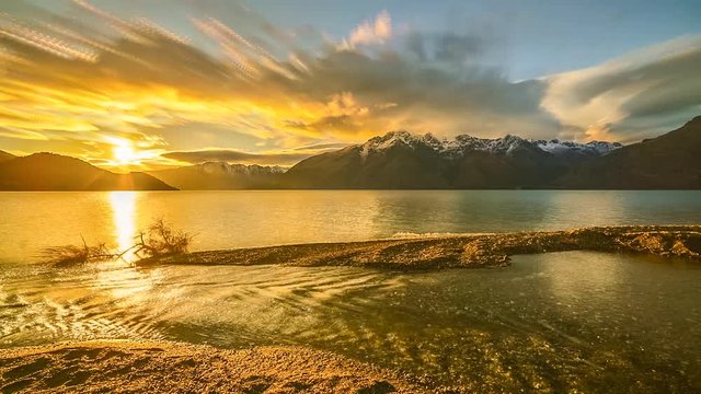 Time lapse of Sunriset at Wakatipu Lake, New Zealand.
Time lapse with stacked images creating artistic soft brush stroke effect on the clouds.