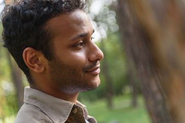 Dreamful guy relaxing in park