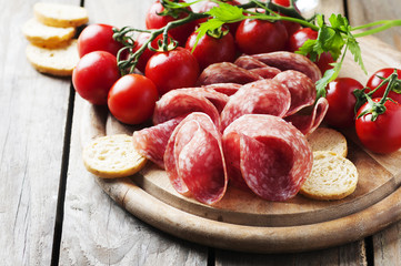 Fresh salami with tomato and bread