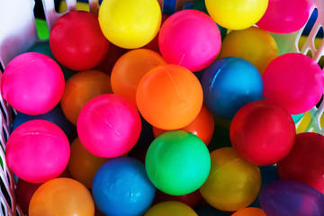 Fototapeta na wymiar Many color plastic balls on a basket