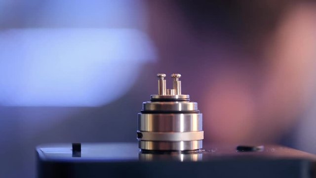 Accepted atomizer from electronic cigarette in a disassembled form closeup.