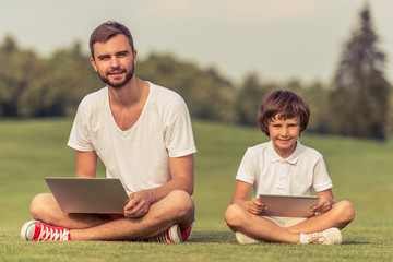 Dad and son with gadget