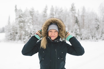 Finland, Jyvaskyla, Saakoski, Portrait of young woman in winter coat
