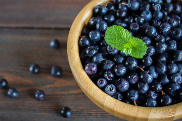 blueberries in a bowl on wooden table
